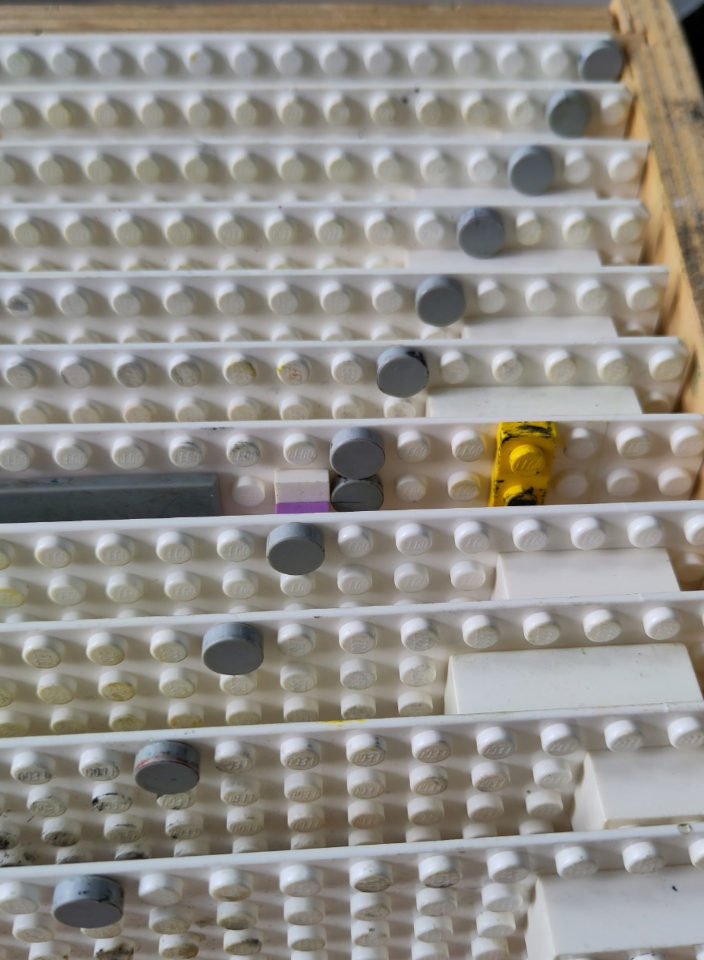 Stacked lego plates with a gray dot on each to indicate the order of printing.